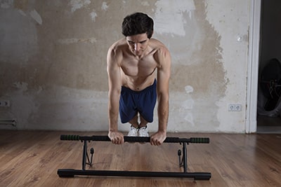 portable chin up bar used by man on floor