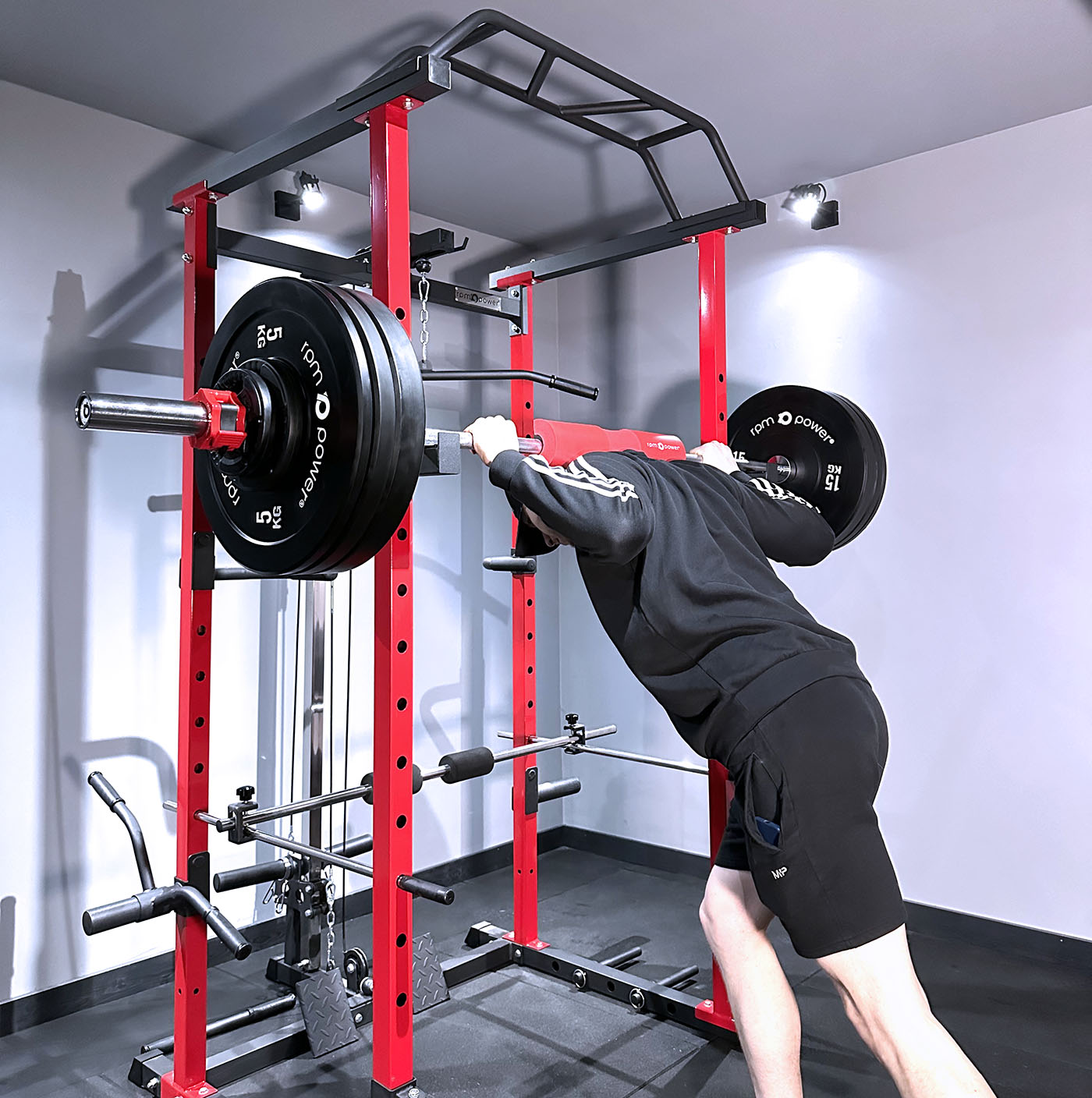 weight lifting squat rack, weight plates and barbell.